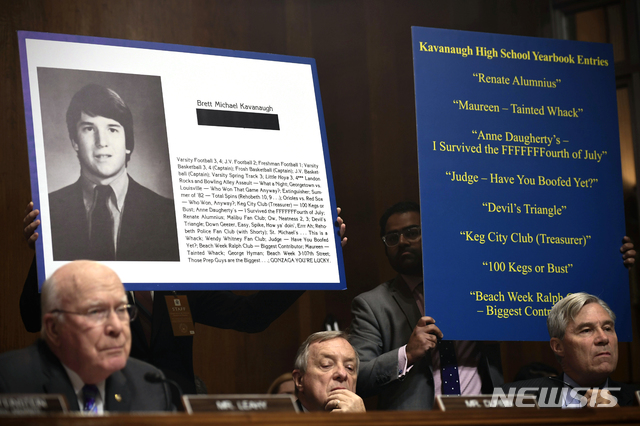 From left, Sen. Patrick Leahy, D-Vt., Sen Dick Durbin, D-Ill., and Sen. Sheldon Whitehouse, D-R.I., listen to the testimony of Supreme Court nominee Brett Kavanaugh before the Senate Judiciary Committee on Capitol Hill in Washington, Thursday, Sept. 27, 2018. Extracts of his high school yearbook are displayed. (Saul Loeb/Pool Image via AP)