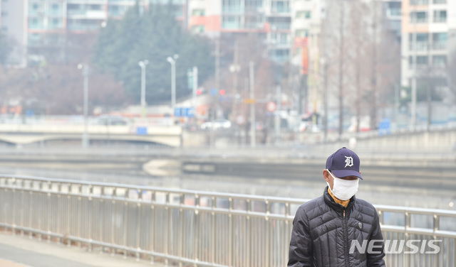 【대구=뉴시스】우종록 기자 = 대구에 초미세먼지 주의보가 발령된 지난 20일 오후 대구 중구 동신교 신천둔치에서 한 시민이 마스크를 착용하고 걸어가고 있다. 2018.12.20. wjr@newsis.com