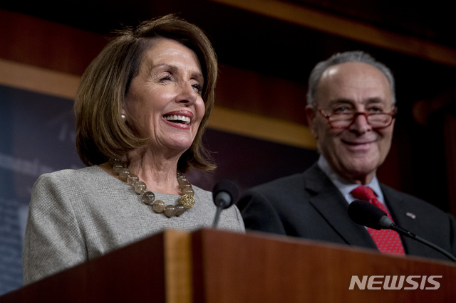 House Speaker Nancy Pelosi of Calif., and Senate Minority Leader Sen. Chuck Schumer of N.Y., smile during a news conference on Capitol Hill in Washington, Friday, Jan. 25, 2019, after President Donald Trump announces a deal to reopen the government for three weeks. (AP Photo/Andrew Harnik)