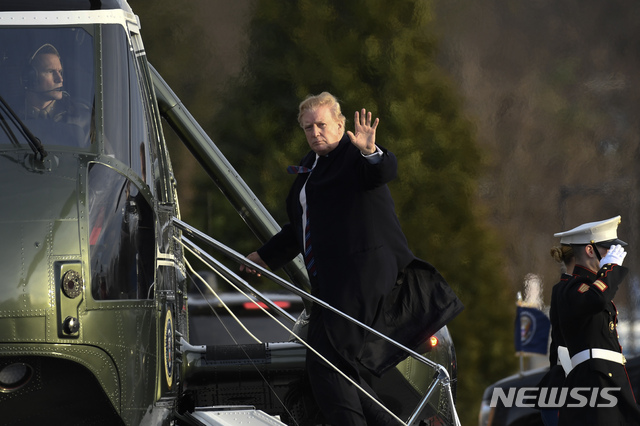 President Donald Trump waves as he walks up the steps of Marine One at Walter Reed National Military Medical Center in Bethesda, Md., Friday, Feb. 8, 2019, after having his annual physical. Trump is in for some poking and prodding as doctors assess his health during his second annual medical checkup as president. (AP Photo/Susan Walsh)