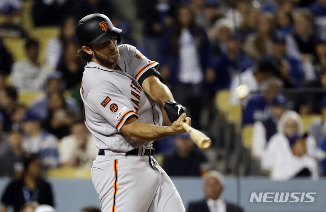 San Francisco Giants&#039; Madison Bumgarner hits a two-run home run against the Los Angeles Dodgers during the sixth inning of a baseball game, Tuesday, April 2, 2019, in Los Angeles. (AP Photo/Marcio Jose Sanchez)