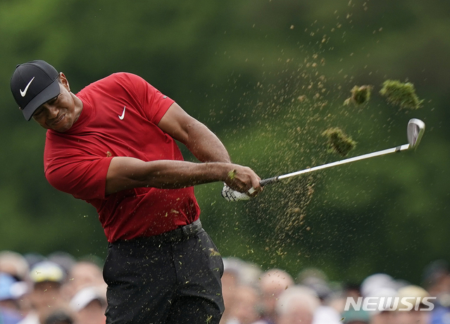 Tiger Woods hits on the 12th hole during the final round for the Masters golf tournament, Sunday, April 14, 2019, in Augusta, Ga. (AP Photo/David J. Phillip)