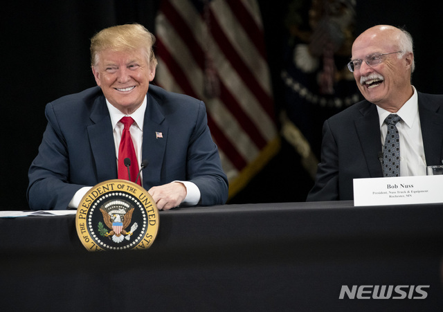 President Donald J. Trump spoke at Nuss Truck and Equipment in Burnsville during a roundtable discussion on tax cuts and the U.S. economy in Burnsville, Minn., on Monday, April 15, 2019. At right is the president of Nuss Truck and Equipment Bob Nuss. (Renee Jones Schneider/Star Tribune via AP)