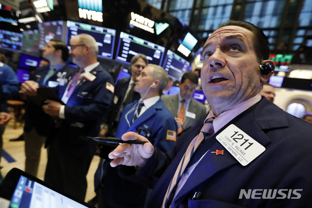 FILE - In this Thursday, April 18, 2019, file photo, Tommy Kalikas, right, works with fellow traders on the floor of the New York Stock Exchange during the Brigham Minerals IPO. Stock investors had to go on a harrowing round trip over the last seven months, but the market may be in a healthier place after it. The S&P 500 index of big U.S. stocks is back to a record high, closing above 2,930 on Tuesday for the first time since Sept. 20. (AP Photo/Richard Drew, File)