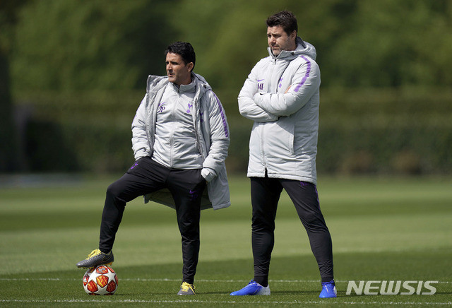 Tottenham Hotspur manager Mauricio Pochettino, right and assistant manager Jesus Perez oversee a training session at Enfield Training Ground, London, Monday April 29, 2019. Tottenham Hotspur will play Ajax in a Champions League semi final soccer match on Tuesday. (John Walton/PA via AP)