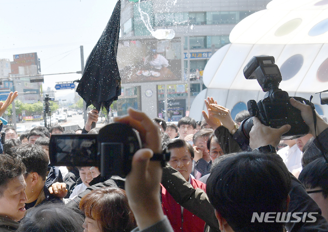 【광주=뉴시스】류형근 기자 = 자유한국당 황교안 대표가 3일 오전 광주 광산구 광주송정역광장에서 '문재인 STOP! 광주시민 심판합니다' 행사를 마친 뒤 빠져나갈 때 지역 5·18 단체 등 시민단체가 플라스틱 물병을 던지며 항의하고 있다. 2019.05.03 hgryu77@newsis.com