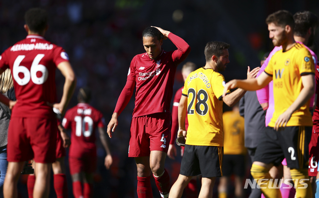 Liverpool&#039;s Virgil van Dijk, center, reacts at the end of the English Premier League soccer match between Liverpool and Wolverhampton Wanderers at the Anfield stadium in Liverpool, England, Sunday, May 12, 2019. Despite a 2-0 win over Wolverhampton Wanderers, Liverpool missed out on becoming English champion for the first time since 1990 because title rival Manchester City beat Brighton 4-1. (AP Photo/Dave Thompson)