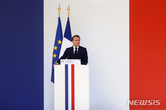 French President Emmanuel Macrondelivers a speech during a national tribute for late special forces soldiers Cedric de Pierrepont and Alain Bertoncello, who were killed in a night-time rescue of four foreign hostages including two French citizens in Burkina Faso last week, during a national tribute at the Invalides, in Paris, Tuesday, May 14, 2019. France is honoring two special forces officers killed in an operation that freed four hostages held in Burkina Faso. (Philippe Wojazer/Pool via AP)