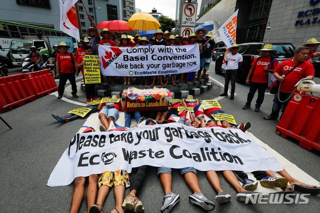 필리핀 주재 캐나다 대사관 앞에서 시민들이 쓰레기를 다시 가져가라는 시위를 하고 있다 <뉴욕타임스 캡쳐>