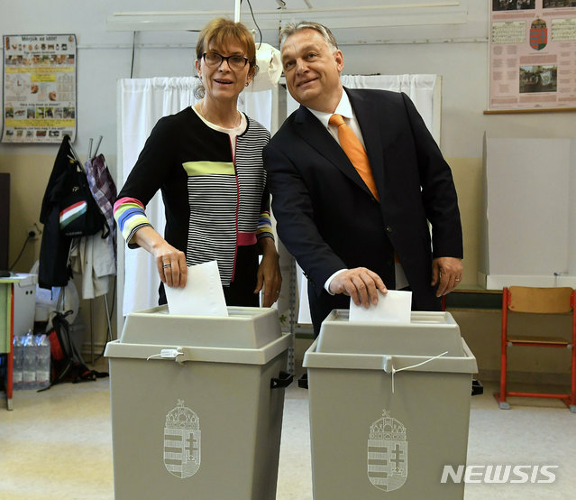 【부다페스트=AP/뉴시스】26일(현지시간) 헝가리 부다페스트의 투표소의 빅토르 오르반 총리부부가 투표하고 사진촬영을 하고 있다. 오르반 총리가 이끄는 피데스당은 유럽 의회선거에서 56%의 득표율을 기록할 것으로 예상됐다. 2019.05.27