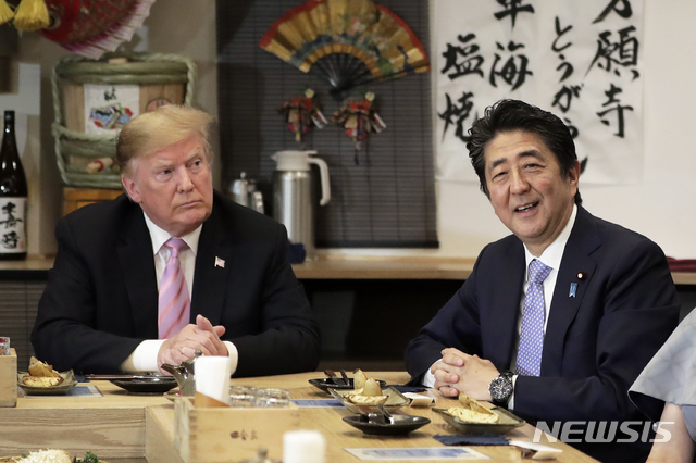 Japan Prime Minister Shinzo Abe, right, speaks during dinner with U.S. President Donald Trump at the Inakaya restaurant in the Roppongi district of Tokyo, Sunday, May 26, 2019. (Kiyoshi Ota/Pool Photo via AP)
