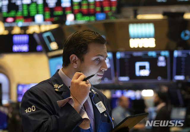 FILE - In this July 5, 2019, file photo trader Benjamin Tuchman works at the New York Stock Exchange in New York. The U.S. stock market opens at 9:30 a.m. EDT on Thursday, July 11. (AP Photo/Mark Lennihan, File)