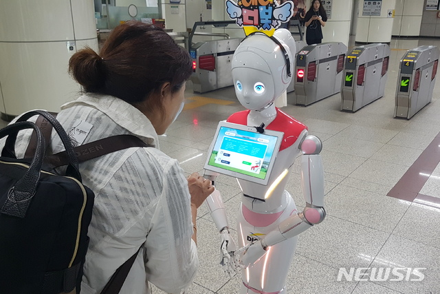 【대전=뉴시스】대전 정부청사역 펀스테이션에 배치된 인공지능로봇 디봇이 승객과 대화를 나누고 있다. 