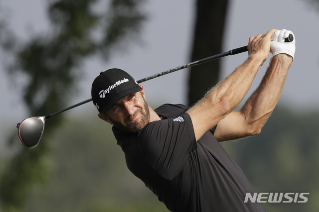 Dustin Johnson tees off on the 13th hole in the Northern Trust tournament at Liberty National Golf Course, Thursday, Aug. 8, 2019, in Jersey City, N.J. (AP Photo/Mark Lennihan)