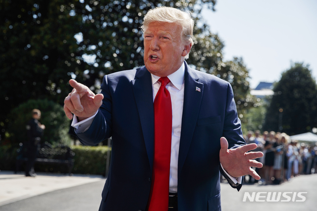 President Donald Trump talks to reporters on the South Lawn of the White House, Friday, Aug. 9, 2019, in Washington, as he prepares to leave Washington for his annual August holiday at his New Jersey golf club. (AP Photo/Evan Vucci)