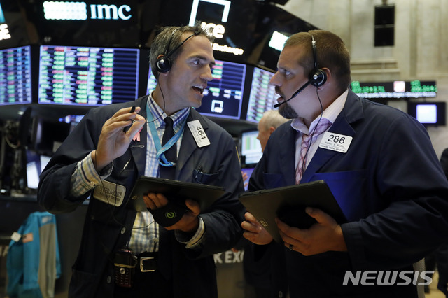 Traders Gregory Rowe, left, and Michael Milano work on the floor of the New York Stock Exchange, Monday, Aug. 19, 2019. Technology stocks were leading indexes higher on Wall Street after the U.S. gave Chinese telecom giant Huawei another 90 days to buy equipment from American suppliers. (AP Photo/Richard Drew)