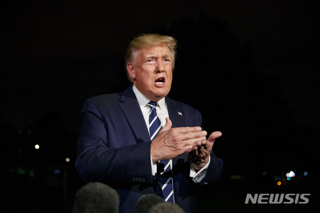 President Donald Trump speaks with reporters as he walks to Marine One on the South Lawn of the White House, Friday, Aug. 23, 2019, in Washington. Trump is en route to the G-7 summit in France. (AP Photo/Alex Brandon)