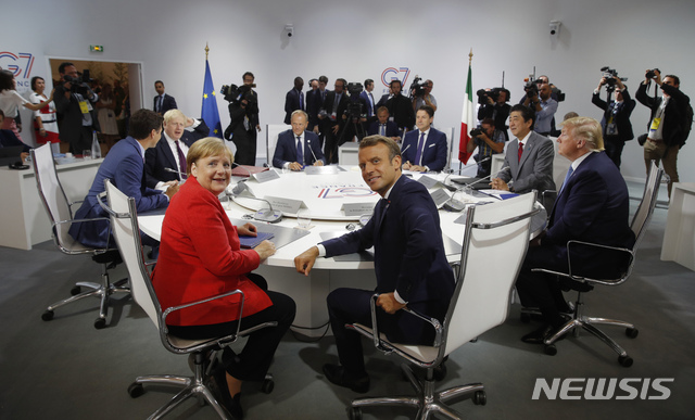 French President Emmanuel Macron, center, U.S. President Donald Trump, right, Japan&#039;s Prime Minister Shinzo Abe, second right, Britain&#039;s Prime Minister Boris Johnson, second left, German Chancellor Angela Merkel , center left, Canada&#039;s Prime Minister Justin Trudeau, Italy&#039;s Prime Minister Giuseppe Conte, rear right, and European Council President Donald Tusk attend a G7 working session on &quot;International Economy and Trade, and International Security Agenda&quot; during the G7 summit in Biarritz, southwestern France, Saturday Aug. 25, 2019. (Philippe Wojazer/Pool via AP)
