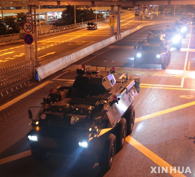 (190829) -- HONG KONG, Aug. 29, 2019 (Xinhua) -- Military vehicles of the Chinese People&#039;s Liberation Army (PLA) pass Huanggang Port for a routine troop rotation in south China&#039;s Hong Kong, Aug. 29, 2019. The Hong Kong Garrison of the Chinese PLA conducted the 22nd rotation of its members in the wee hours of Thursday since it began garrisoning Hong Kong in 1997. (Photo by Yuan Junmin/Xinhua)