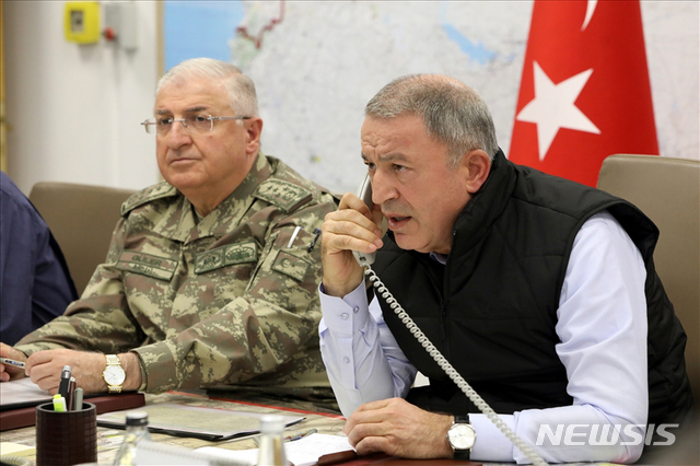 【앙카라=AP/뉴시스】 훌루시 아카르 터키 국방장관이 9일(현지시간) 터키 앙카라에 위치한 육군본부 작전실에서 통화를 하고 있다. 터키 국방부는 이날 "터키군은 '평화의 샘' 작전의 하나로 공군 등 지원 사격을 통해 테러조직 181개를 타격했다"고 발표했다. 2019.10.10.