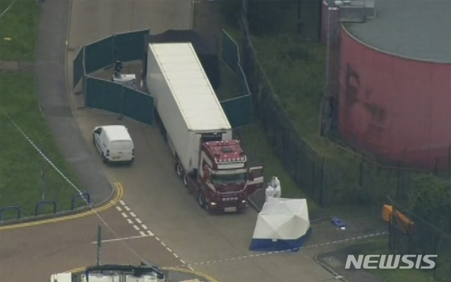 An aerial view as police forensic officers attend the scene after a truck was found to contain a large number of dead bodies, in Thurock, South England, early Wednesday Oct. 23, 2019. Police in southeastern England said that 39 people were found dead Wednesday inside a truck container believed to have come from Bulgaria. (UK Pool via AP)