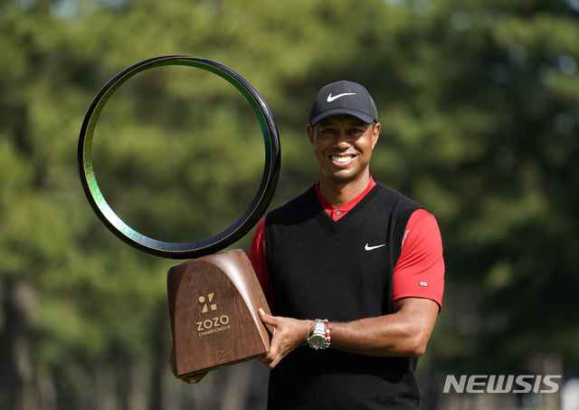 Tiger Woods of the United States poses with his trophy after winning the Zozo Championship PGA Tour at the Accordia Golf Narashino country club in Inzai, east of Tokyo, Japan, Monday, Oct. 28, 2019. (AP Photo/Lee Jin-man)