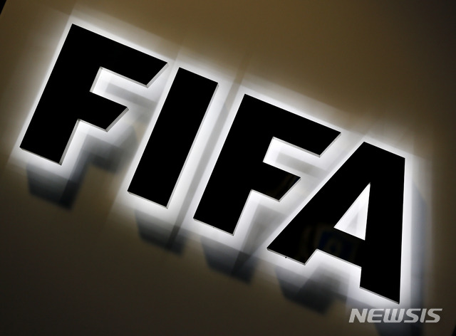 FILE - This Sept. 25, 2015 file photo shows the FIFA logo outside FIFA headquarters in Zurich, Switzerland. FIFA has told soccer&#039;s biggest agents who are resisting limits to their cut of deals that there is a necessity to &quot;curb the excesses&quot; of the $7 billion annual transfer market. Agent earnings from transfers would be capped at a maximum 10% of fees when acting for the selling club under changes set to be introduced from 2021. (AP Photo/Michael Probst, file)
