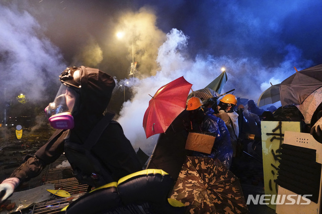 【홍콩=AP/뉴시스】17일 홍콩 이공대(폴리테크닉대) 캠퍼스에서 시위대가 우산 등으로 경찰이 쏜 최루탄을 막고 있다. 2019.11.18 