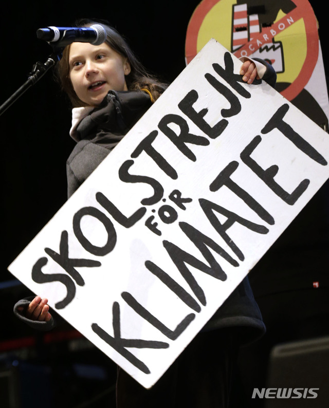 [마드리드=AP/뉴시스]스웨덴 출신의 16세 환경 운동가 그레타 툰베리가 6일(현지시간) 스페인 마드리드에서 열린 기후변화 시위에 참석해 발언하고 있다. 그가 든 푯말에는 '기후를 위한 파업'이라는 문구가 적혀 있다. 2019.12.7.