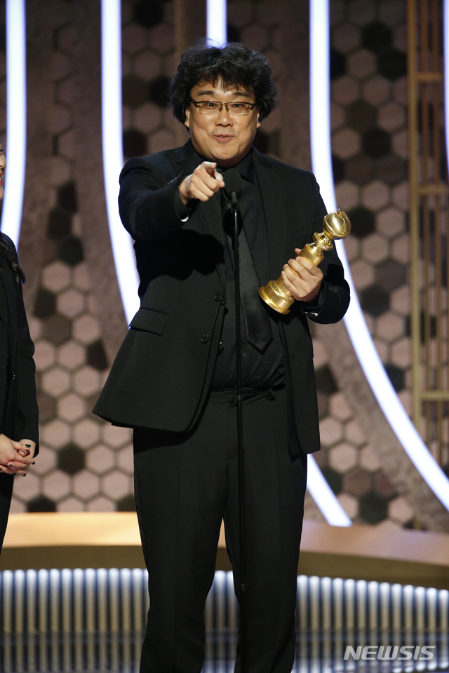 This image released by NBC shows Bong Joon Ho accepting the award for best foreign language film for &quot;Parasite&quot; at the 77th Annual Golden Globe Awards at the Beverly Hilton Hotel in Beverly Hills, Calif., on Sunday, Jan. 5, 2020. (Paul Drinkwater/NBC via AP)