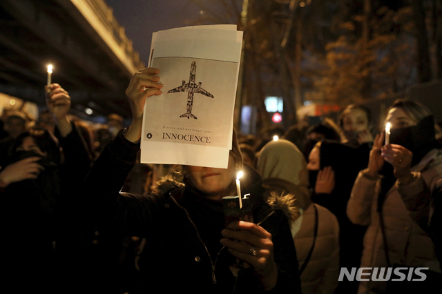 People gather for a candlelight vigil to remember the victims of the Ukraine plane crash, at the gate of Amri Kabir University that some of the victims of the crash were former students of, in Tehran, Iran, Saturday, Jan. 11, 2020. Iran on Saturday, Jan. 11, acknowledged that its armed forces &quot;unintentionally&quot; shot down the Ukrainian jetliner that crashed earlier this week, killing all 176 aboard, after the government had repeatedly denied Western accusations that it was responsible. (AP Photo/Ebrahim Noroozi)