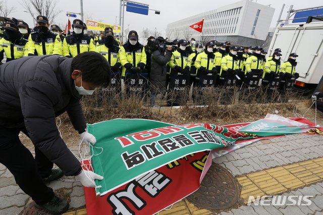 [진천=뉴시스] 인진연 기자= 31일 충북 진천군 국가공무원인재개발원 정문에 붙은 우한 교민의 입소를 반대하는 현수막을 진천군민들이 자체 철거하고 있다. 2020.01.31.inphoto@newsis.com