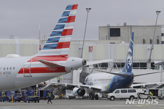 [ 시애틀= AP/뉴시스]  올 2월 13일 미국 시애틀타코마 국제공항에 계류중인 알래스카 항공사 여객기(오른쪽) .  알래스카항공과 사우스웨스트 항공 등 국내 항공사들은 코로나19로 탑승객은 줄고 예약취소는 폭증해 앞으로 몇 달간 운항편수를 대폭 줄인다고 밝혔다.   