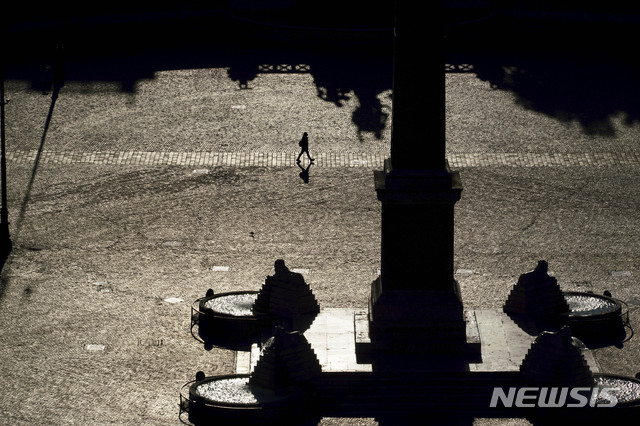 [로마=AP/뉴시스]19일(현지시간) 이탈리아 로마의 인적 없는 포폴로 광장에 한 시민이 걸어가고 있다. 2020.03.20.