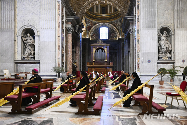 [바티칸=AP/뉴시스] 프란치스코 교황(왼쪽)이 5일(현지시간) 바티칸 성베드로 대성당에서 부활절을 앞둔 수난성지주일 미사를 비공개로 집전하고 있는 가운데 극소수의 참석자들이 서로 거리를 두고 앉아 있다. 2020.04.06
