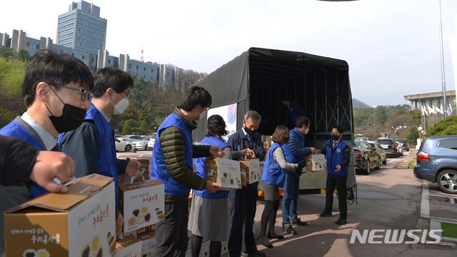 [세종=뉴시스] 한국자유총연맹 회원들이 신종 코로나바이러스 감염증(코로나19)으로 어려움을 겪는 지역 주민들에게 물품을 나눠주고 있다. (사진= 행정안전부 제공) 2020.04.07. 