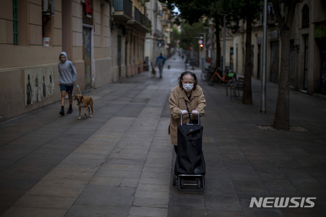 [바르셀로나=AP/뉴시스]7일(현지시간) 스페인 바르셀로나의 한 거리에서 한 노인이 카트를 밀며 이동하고 있다. 2020.04.08.