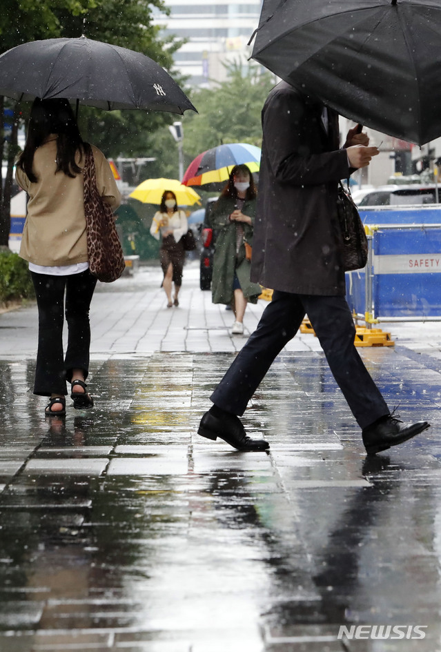 [서울=뉴시스] 최동준 기자 = 지난 19일 서울 홍대입구역 인근에서 시민들이 우산을 쓰고 걸어가고 있다. 2020.05.19. photocdj@newsis.com