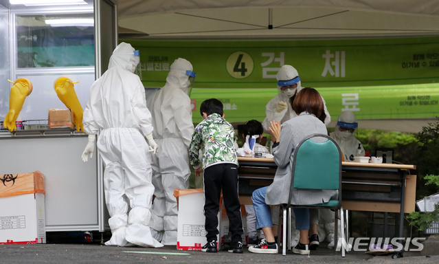 [서울=뉴시스]홍효식 기자 = 연은초등학교 긴급돌봄교실에서 신종 코로나바이러스 감염증(코로나19) 확진자가 발생한 26일 서울 은평구 연은초등학교 인근 시립은평병원에 마련된 선별진료소에서 어린이들이 보호자와 함께 검사를 받기 위해 기다리고 있다. 2020.05.26. yesphoto@newsis.com