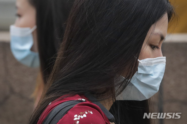 [베이징=AP/뉴시스]28일 중국 베이징의 한 거리에서 코로나19 확산 예방을 위해 마스크를 쓴 여성들이 서로 지나치고 있다. 2020.07.28.