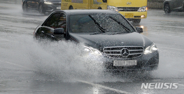 [전주=뉴시스] 김얼 기자 = 장마가 이어지고 있는 28일 전북 전주시 백제교 인근에서 운전자들이 쏟아져 내린 폭우로 빗물에 잠긴 차도를 지나고 있다. 2020.07.28. pmkeul@newsis.com