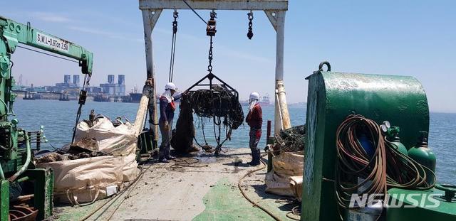 [서울=뉴시스] 해양폐기물 전용수거선 인양틀로 침적쓰레기를 인양하는 모습.