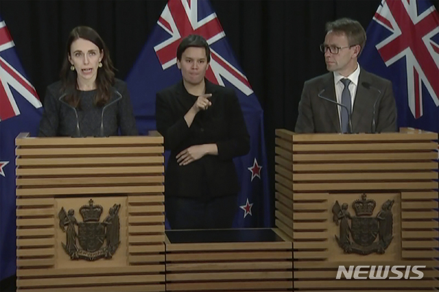 In this image from a video, New Zealand Prime Minister Jacinda Ardern, left, and Director-General of Health Ashley Bloomfield, right, attend a news conference in Wellington, New Zealand Tuesday, Aug. 11, 2020. Ardern says authorities have found four cases of the coronavirus in one Auckland household from an unknown source, the first cases of local transmission in the country in 102 days. (TVNZ via AP)