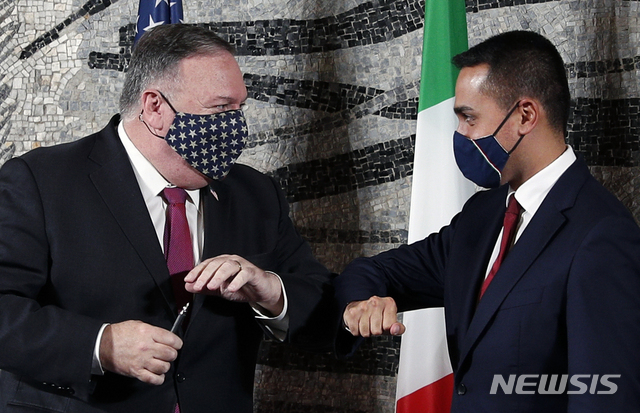 U.S. Secretary of State Mike Pompeo, left, bumps elbows with Italian Foreign Minister Luigi Di Maio in Rome, Wednesday, Sept. 30, 2020. Pompeo is in Italy as part of his six-day trip to Southern Europe. (Guglielmo Mangiapane/Pool Photo via AP)