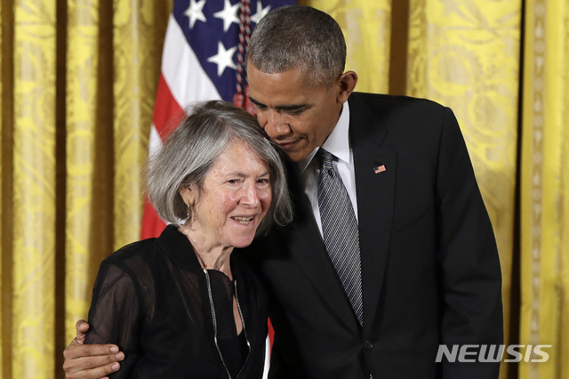 FILE - In this Thursday, Sept. 22, 2016 file photo, President Barack Obama embraces poet Louise Gluck before awarding her the 2015 National Humanities Medal during a ceremony in the East Room of the White House, in Washington. The 2020 Nobel Prize for literature has been awarded to American poet Louise Gluck “for her unmistakable poetic voice that with austere beauty makes individual existence universal.” The prize was announced Thursday Oct. 8, 2020 in Stockholm by Mats Malm, the permanent secretary of the Swedish Academy. (AP Photo/Carolyn Kaster, File)