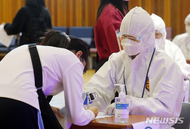 [서울=뉴시스]배훈식 기자 = 성신여자대학교 2021학년도 수시모집 논술고사가 치러진 11일 오후 서울 성북구 성신여대 체육관에서 수험생들이 고사장에 입실하기 전 발열검사를 하고 있다. 2020.10.11. dahora83@newsis.com