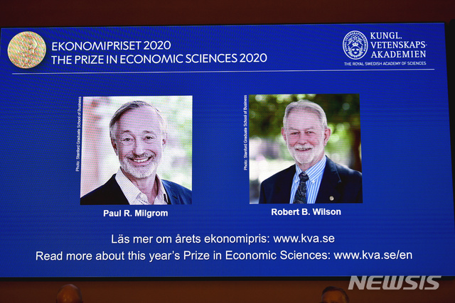Winners of the Sveriges Riksbank Prize in Economic Sciences in Memory of Alfred Nobel for 2020 at a press conference in Stockholm, Monday Oct. 12, 2020. Americans Paul R. Milgrom, left, and Robert B. Wilson have won the Nobel Prize in economics for &quot;improvements to auction theory and inventions of new auction formats.&quot; (Anders Wiklund/TT via AP)