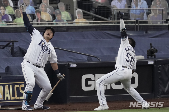 Tampa Bay Rays Randy Arozarena (56) celebrates his two run home run against the Houston Astros with Ji-Man Choi during the first inning in Game 7 of a baseball American League Championship Series, Saturday, Oct. 17, 2020, in San Diego. (AP Photo/Jae C. Hong)
