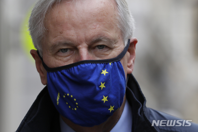 EU Chief negotiator Michel Barnier walks with other members of the EU delegation to the Department for Business, Energy and Industrial strategy for a meeting in London, Friday, Oct. 23, 2020. Barnier is in London to resume talks over post Brexit trade agreements. (AP Photo/Kirsty Wigglesworth)