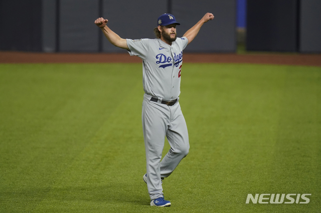 Los Angeles Dodgers starting pitcher Clayton Kershaw warms up before Game 5 of the baseball World Series against the Tampa Bay Rays Sunday, Oct. 25, 2020, in Arlington, Texas. (AP Photo/Eric Gay)